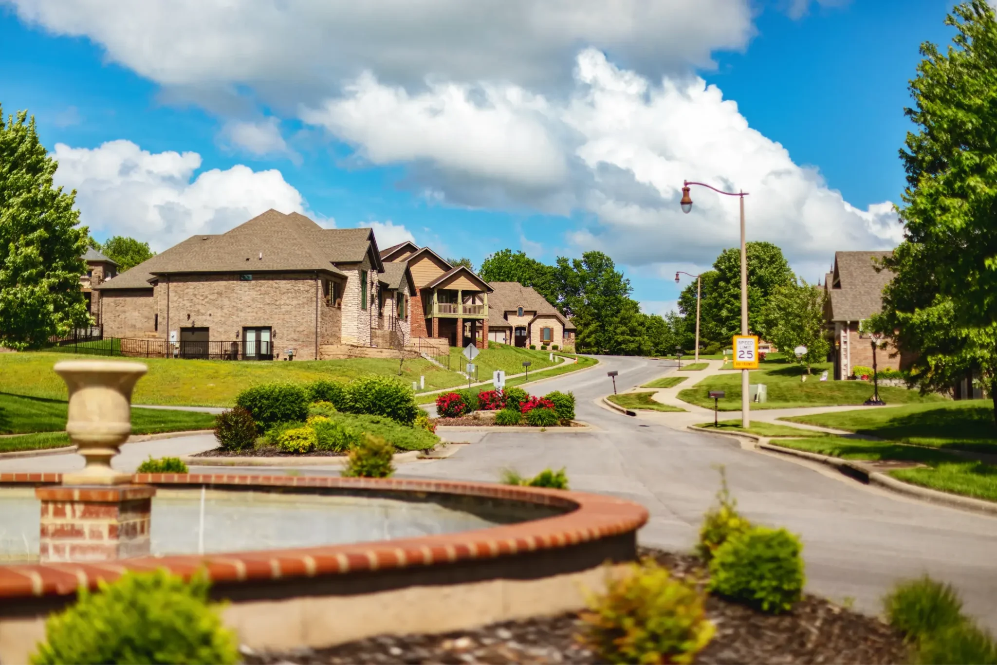 Upscale neighborhood with fountain and homes.