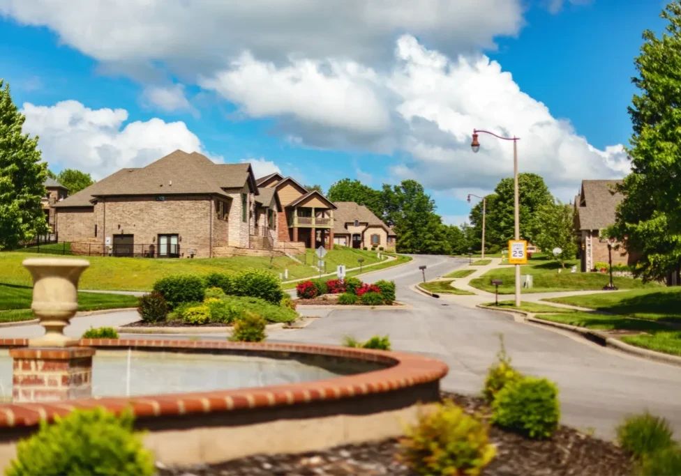 Upscale neighborhood with fountain and homes.